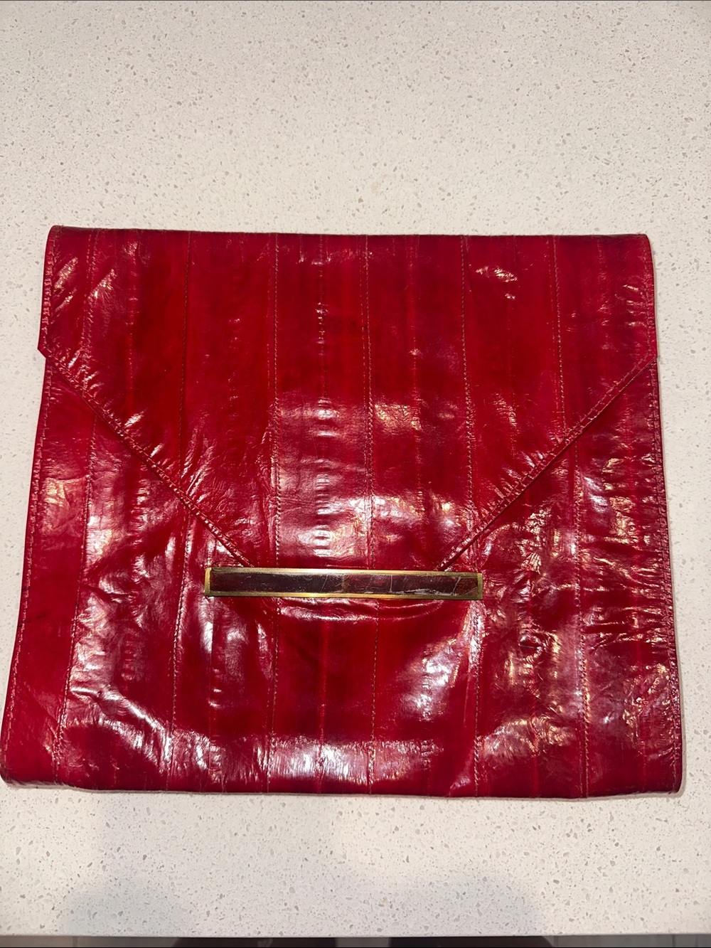 R&Y Augousti patent red leather envelope clutch with gold bar accent